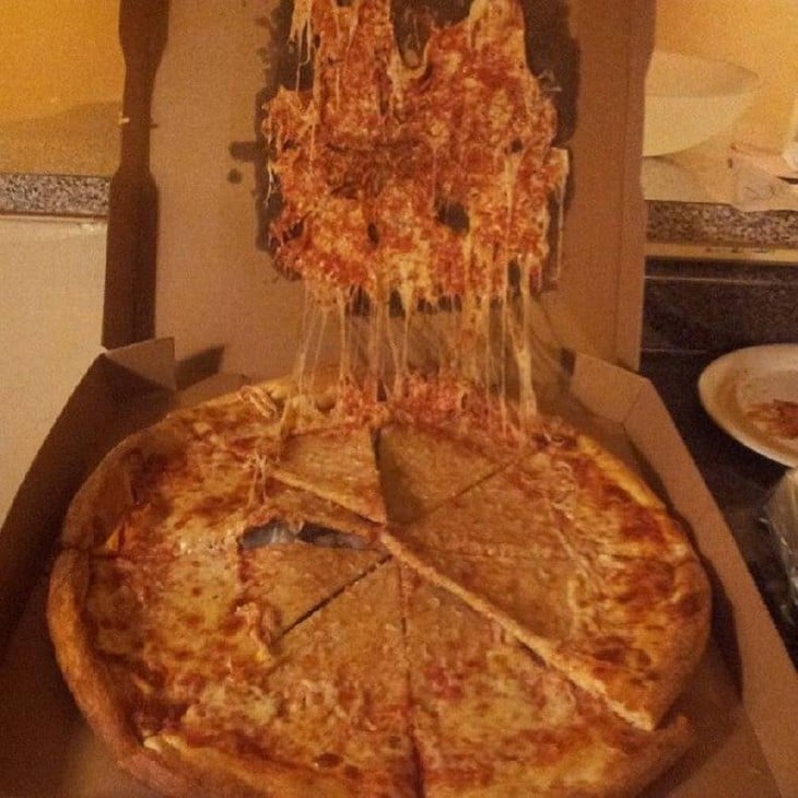 Pizza pegada a la tapa superior de la caja 