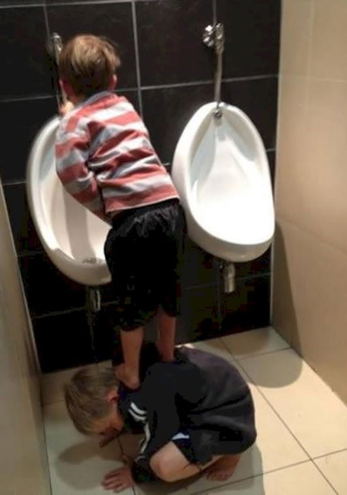 niño hace del baño parado sobre su amigo