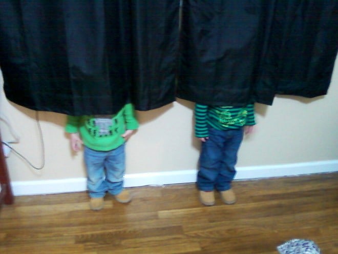 niños escondiéndose detrás de una cortina
