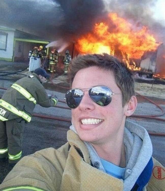 Selfie de un chico que detrás tiene un incendio