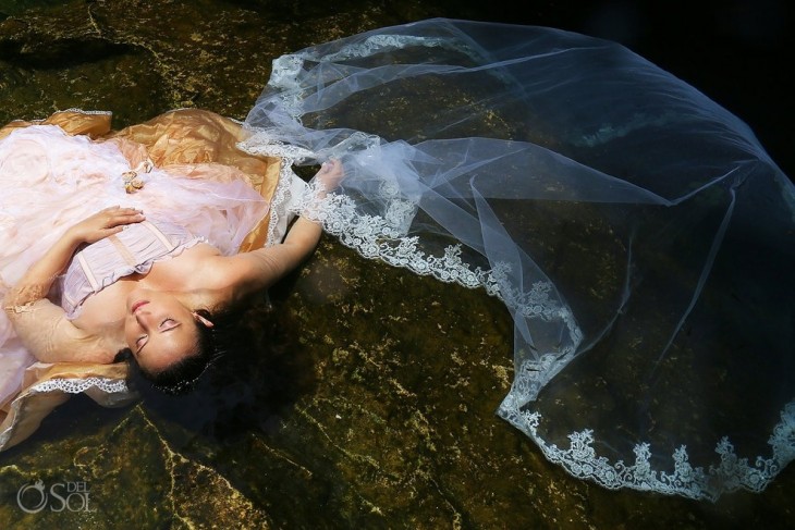 Chica recostada en rocas debajo del agua 