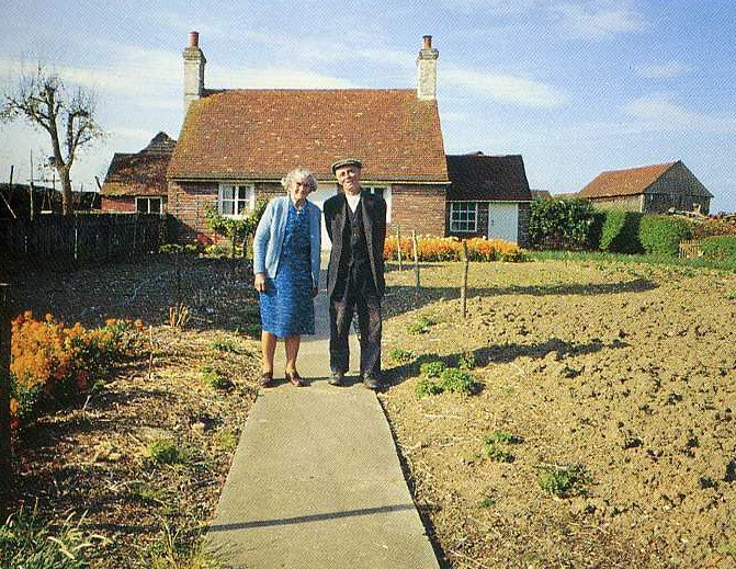 hombre y mujer al frente de su casa verano