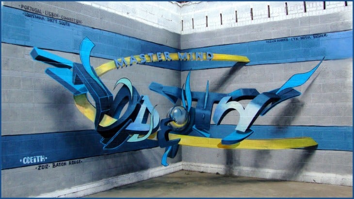Grafiti 3D de color azul con amarillo sobre una pared 