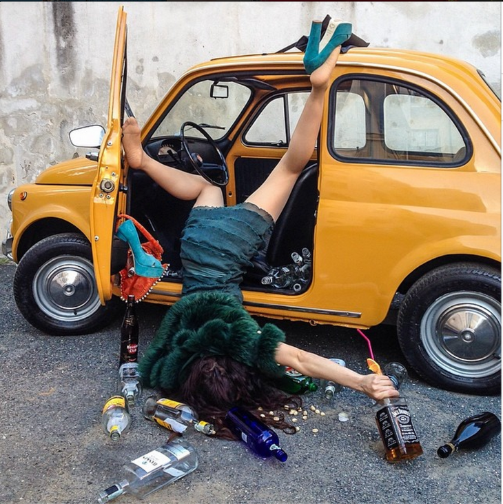 borracha con auto amarillo, cayendo de cara al suelo