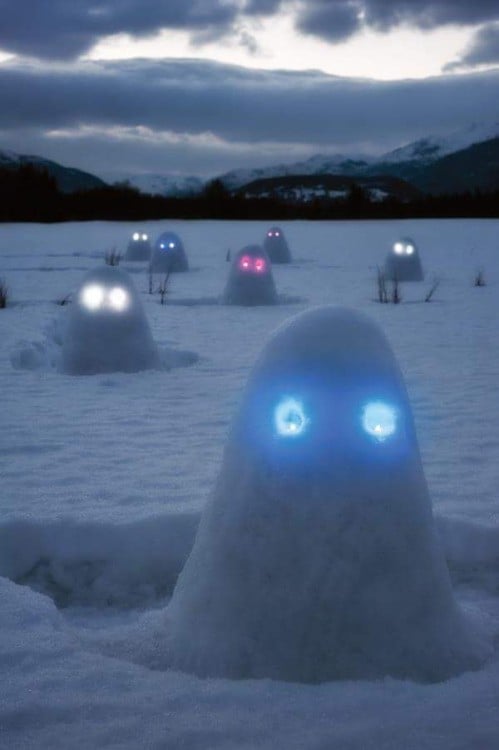 cabezas de nieve en el hielo con luces celestes en los ojos