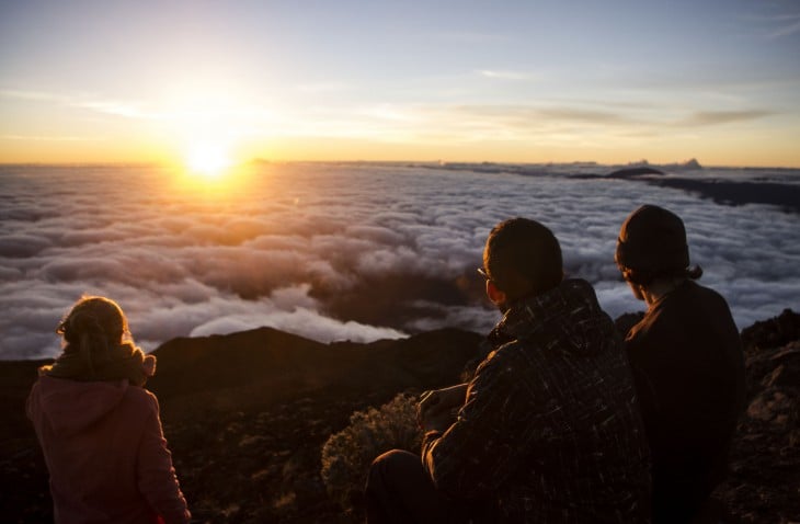 amigos mirando al horizonte en lo alto de una montaña