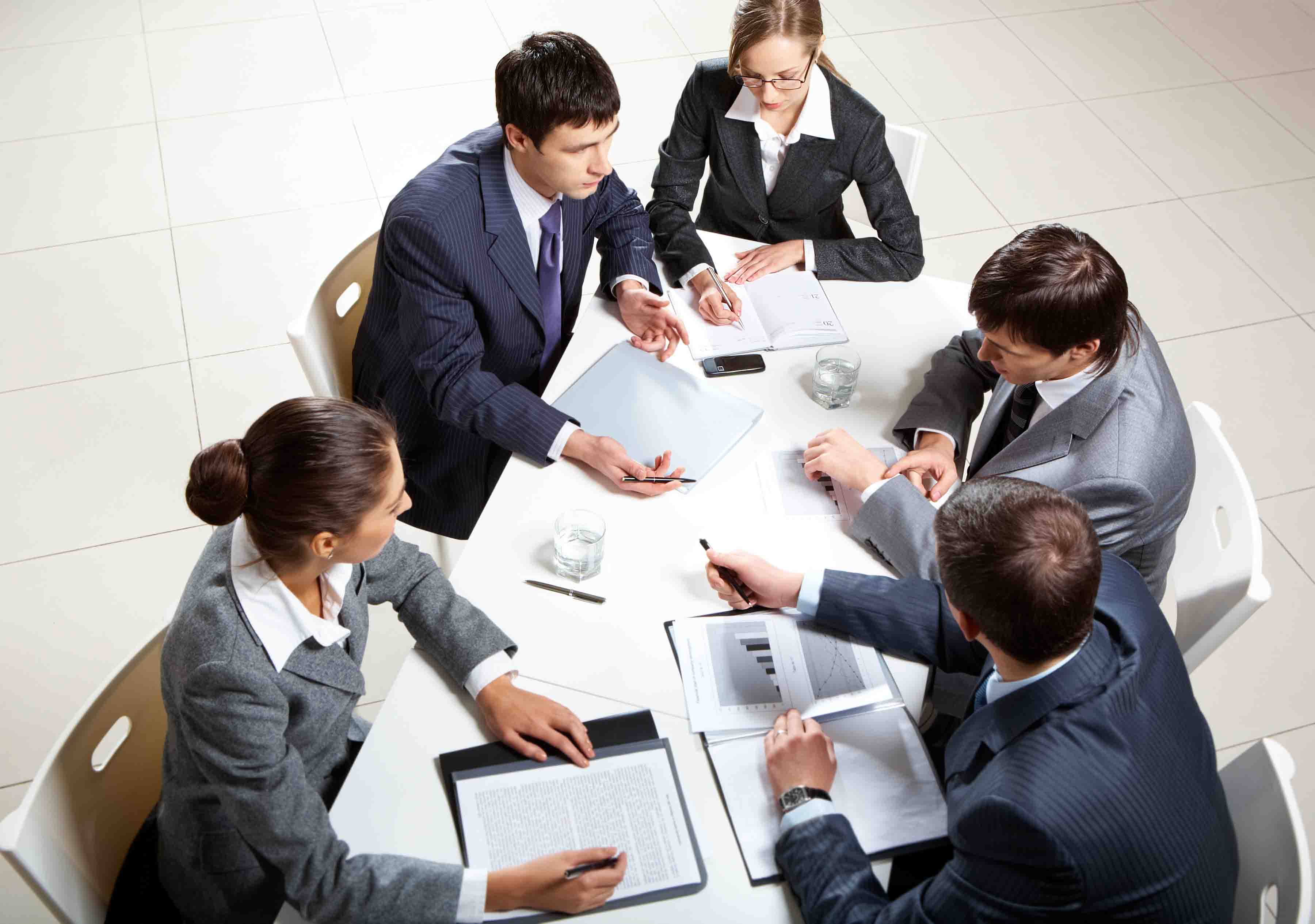 Team of five business people discussing an important question at briefing