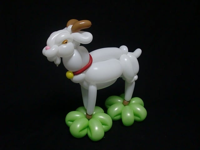 Figura de cabra hecha con globos blancos, verdes y cafés 