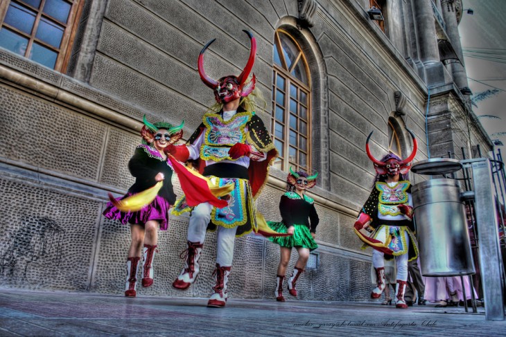 Personas bailando la diablada en una de las calles de Bolivia 