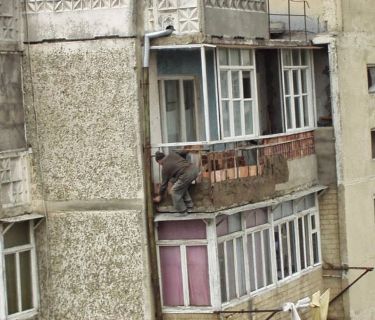 hombre poniendo el enjarre de una de las bardas de las terrazas en los departamentos