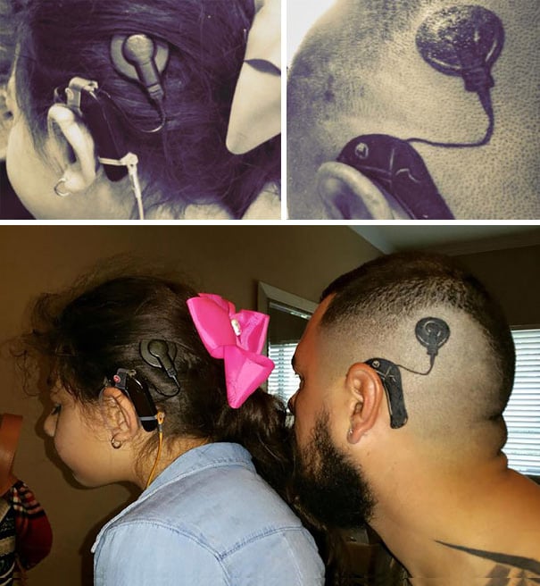 Niña junto a su padre mostrando un tatuaje de un implante coclear en su cabeza 
