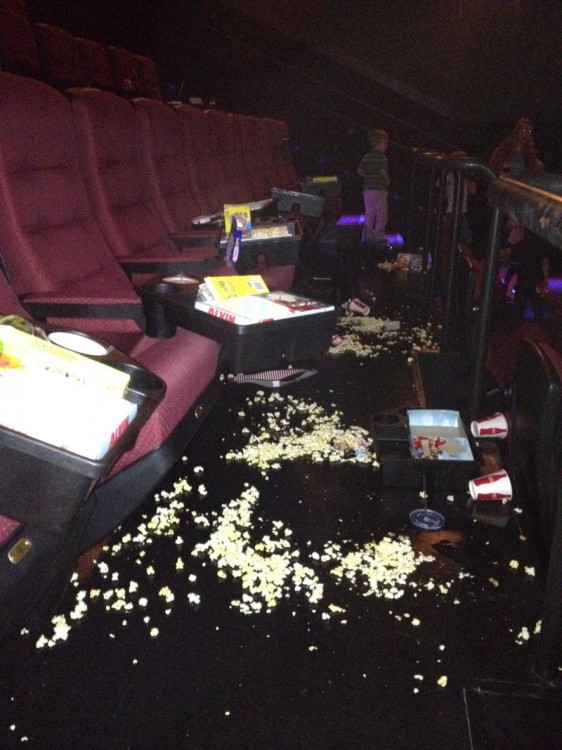 Sala de cine con muchas palomitas tiradas en el suelo 