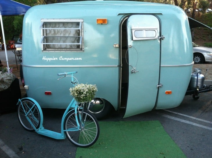 Exterior de un remolque retro en color azul con una bicicleta 