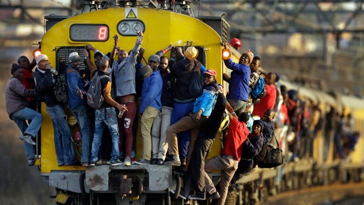 Personas arriba de un tren en Soweto, Sudáfrica