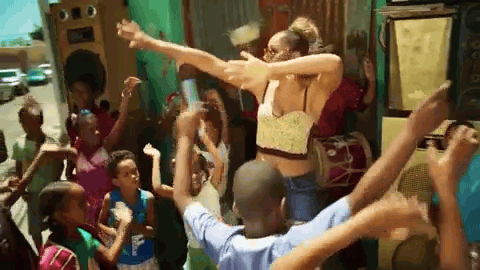 mujer bailando con un monton de niños para un video musical