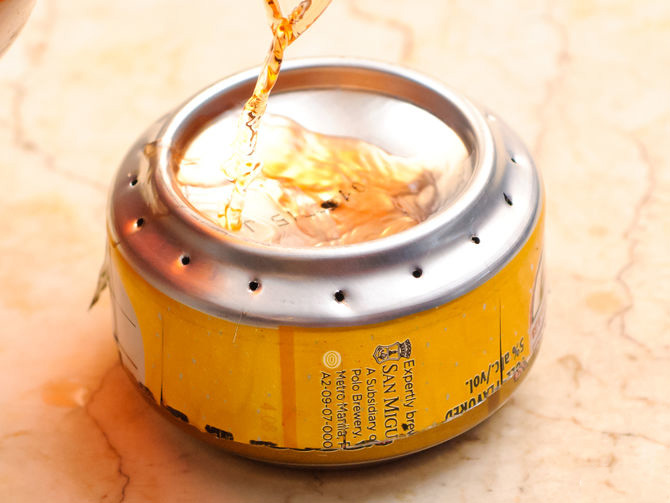 Verter alcohol sobre una lata para hacer un quemado de estufa 
