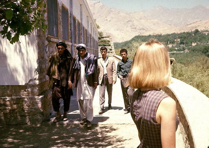 Chica mirando a unos hombres en una calle de Afganistán, 1960 