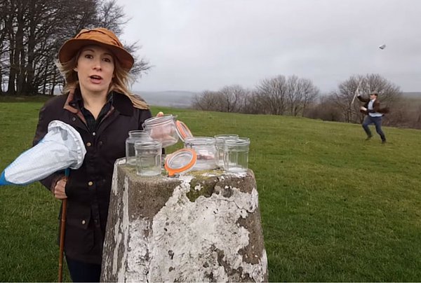 mujer con frascos transparentes en campos británicos 