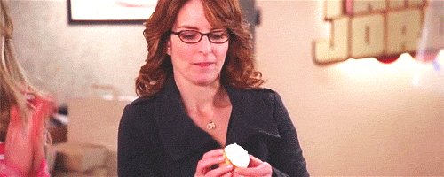 gif de una mujer comiéndose un cupcake como si fuera un sandwich