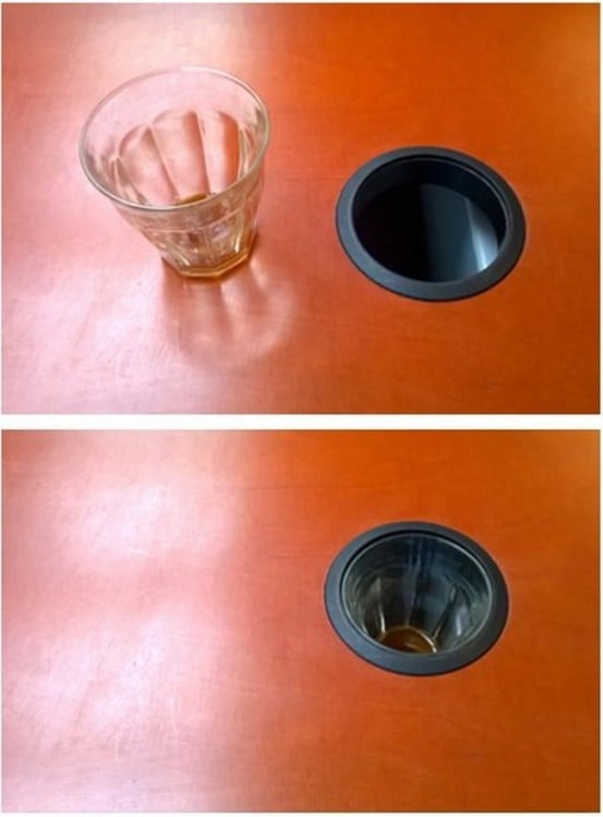 vaso de cristal dentro de un hueco de una mesa 