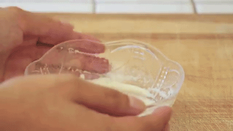 gif que muestra a una chica revolviendo leche con gelatina sin sabor en un recipiente 
