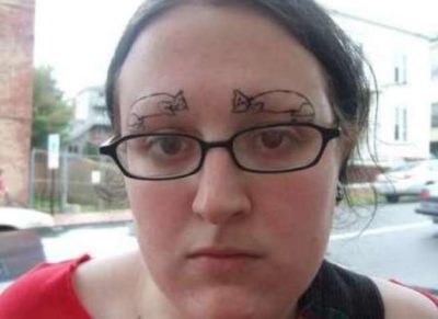 chica con tatuajes de gatos en lugar de cejas