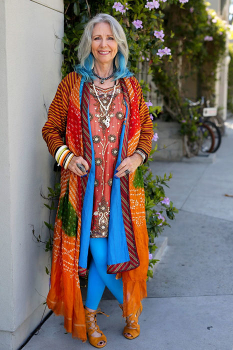Mujer de +60 años vestida con ropa tipo hindue y el cabello pintado de azul 