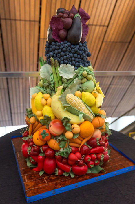 Pastel con forma de frutas y verduras apiladas 