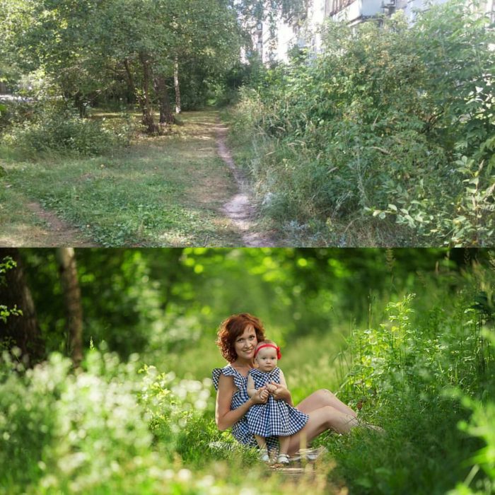 mujer cargando a una bebe en un lugar lleno de plantas