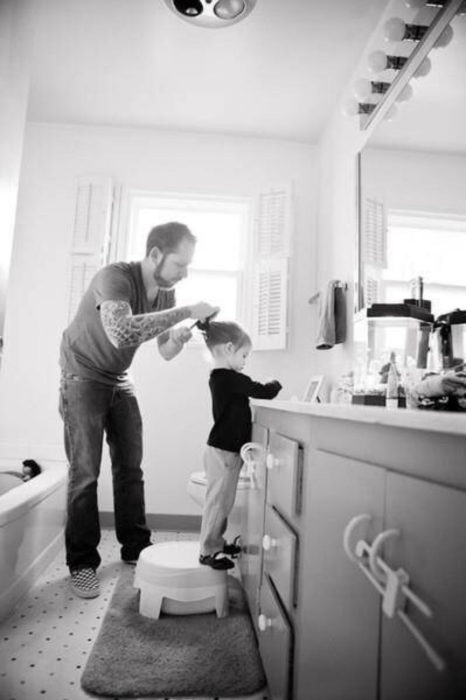 papá peinando a su hija 