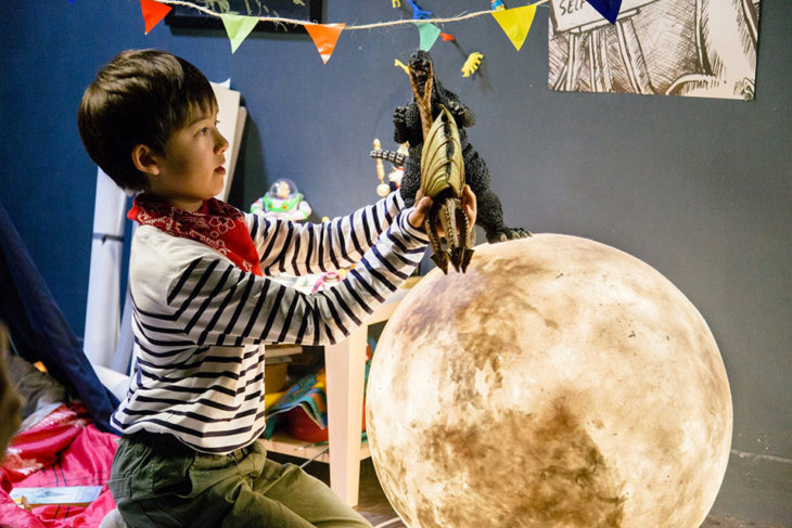 niño jugando con una lámpara de luna