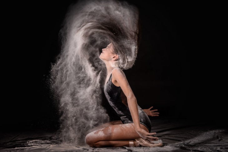 Chica con harina echándose el cabello hacia atras