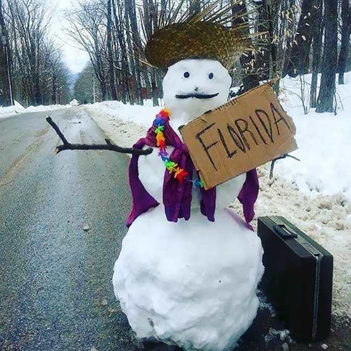 mueco de nieve en carretera con un cartel que dice Florida