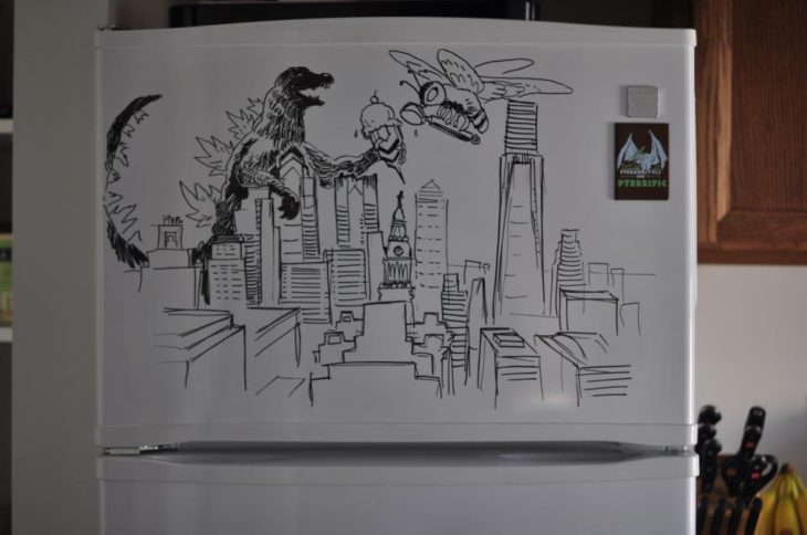 dibujo de godzila atacando la ciudad