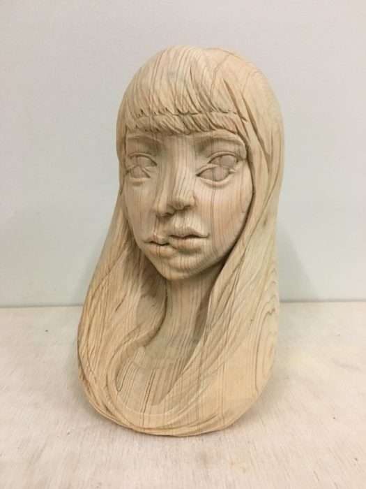 escultura en madera de una mujer