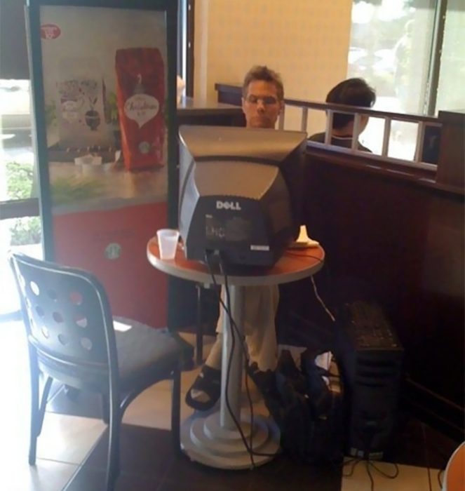 hombre con una pc de escritorio en un restaurante