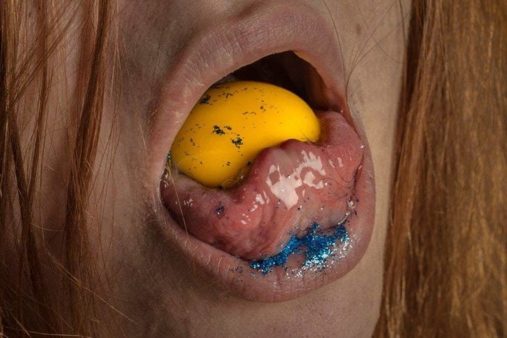 boca de mujer con yema de huevo