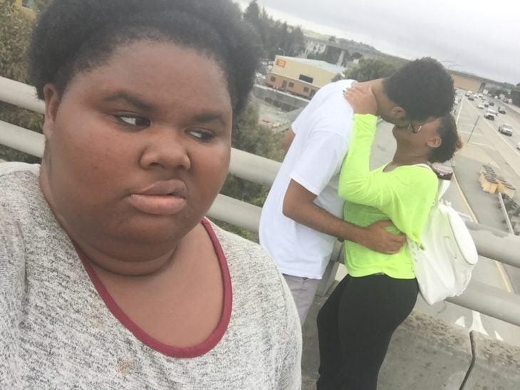 mujer viendo a pareja besándose