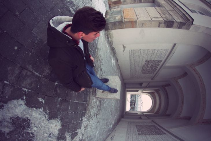 foto de hombre joven en edificio que juega con la perspectiva