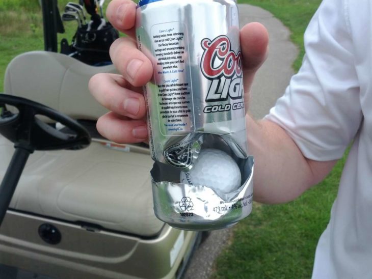 pelota de golf detenida por lata de cerveza