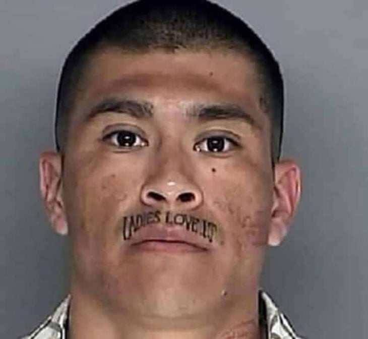 Hombre con bigote tatuado con mensaje
