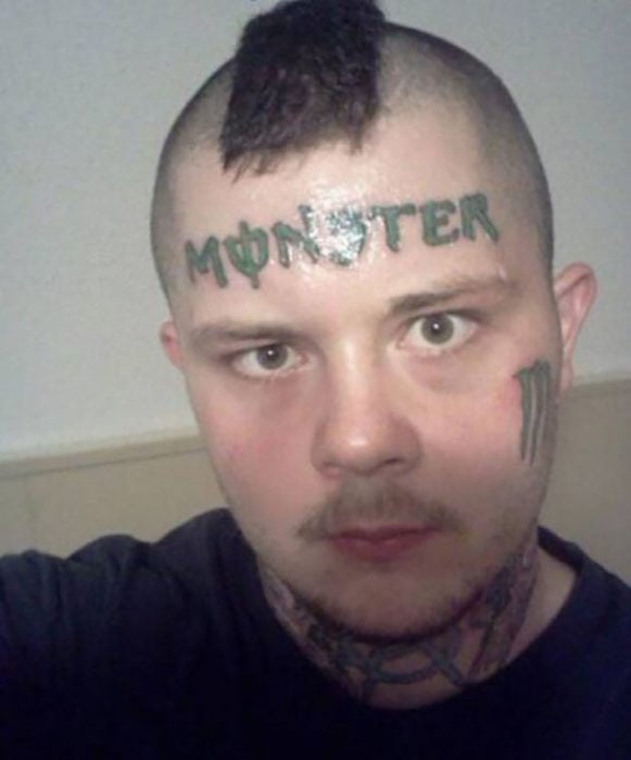 hombre con la marca monster tatuado en la cara