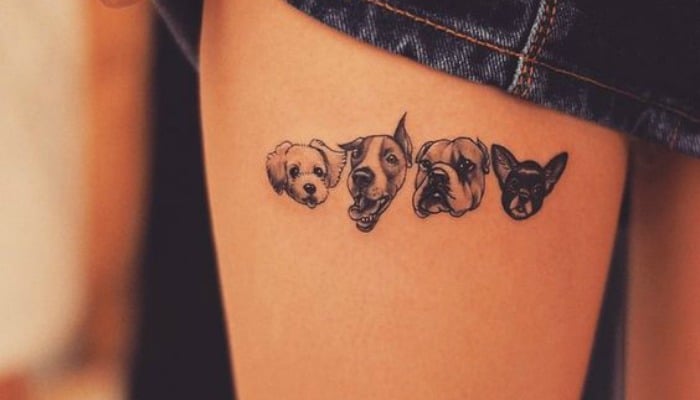 tatuaje de varios perros en la pierna