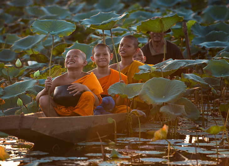 niños en canoa vestidos con trajes naranja