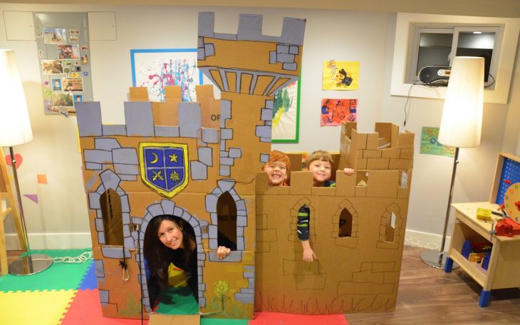 Niños y mamá en castillo de cartón